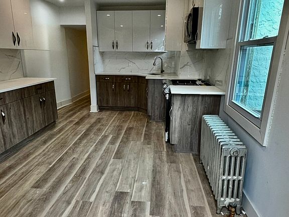 Freshly renovated kitchen, new stainless steel Samsung appliances, side by side refrigerator, new stove, new floors.