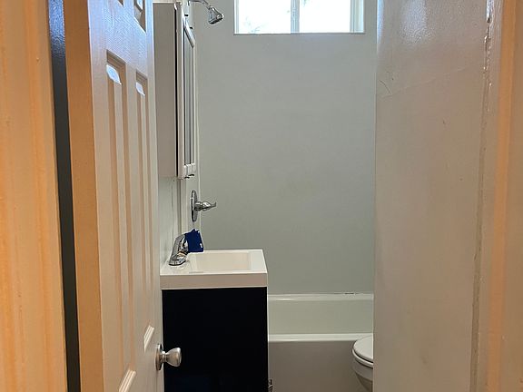 Bathroom - NEW vanity, surround tub/shower, and toilet