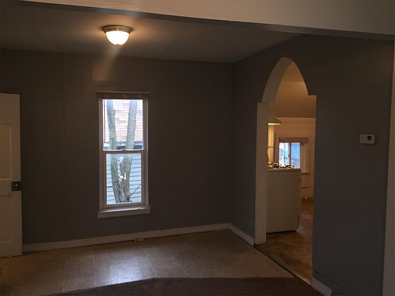 Living room with updated grey paint and newer carpet as it a