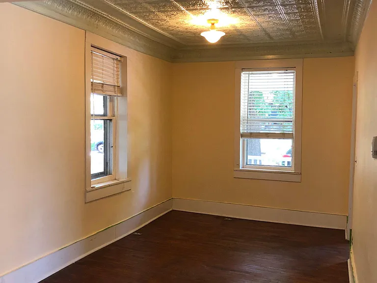 Living room with tin ceilings and wood floors