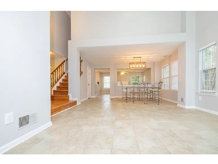 Open vaulted living room and open dining room.