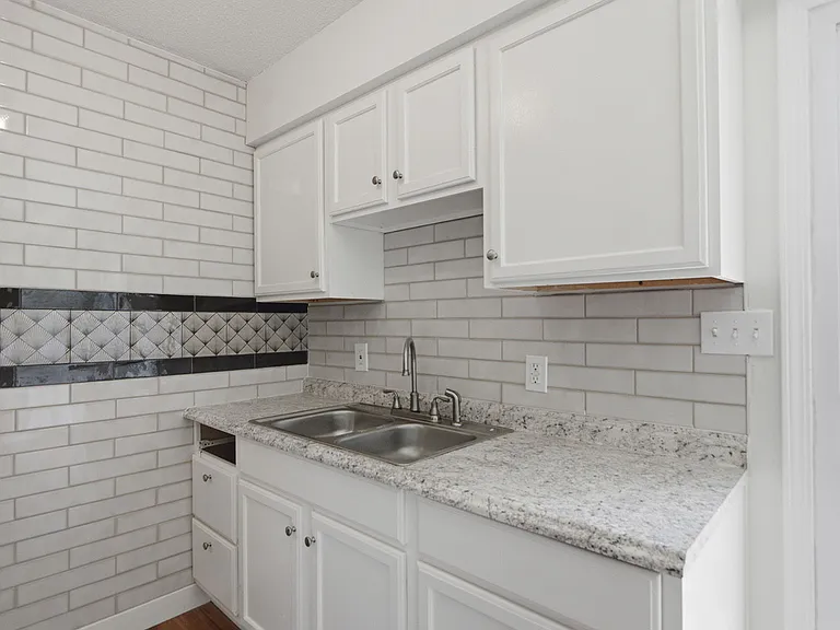 Stylish kitchen features new tile, including a tile accent wall