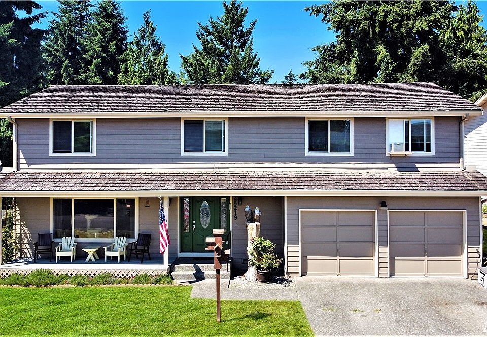 Frontal view of large 2 story on corner lot and welcoming porch!