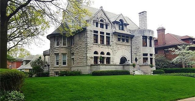 A stunning limestone exterior with Ludowici Tile roof and beautifully landscaped grounds.
