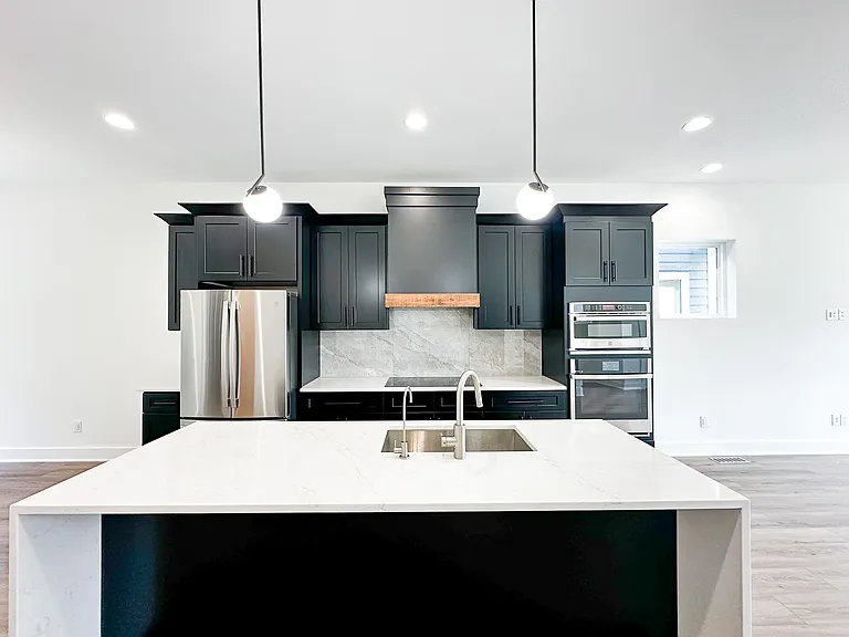 Kitchen Featuring GE Appliances, R/O Filtered Water Tap, Induction Cooktop, and Exterior Vented Hood