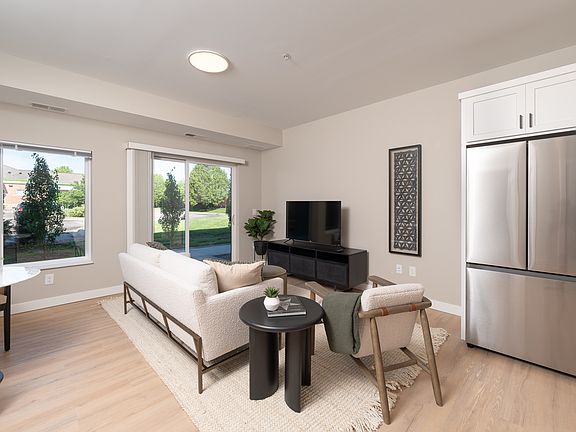 An open living area with oversized windows that bring in natural light.