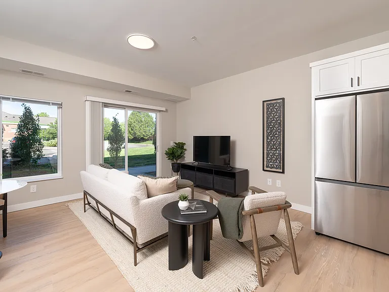 An open living area with oversized windows that bring in natural light.