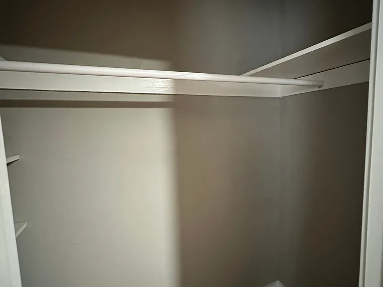 A white closet with shelves at Univeristy Court.