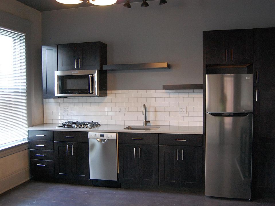 fully equipped kitchen with ample cabinetry and stainless steel appliances