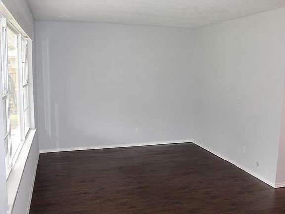 SPACIOUS LIVING AREA WITH RECENTLY INSTALLED FLOORING