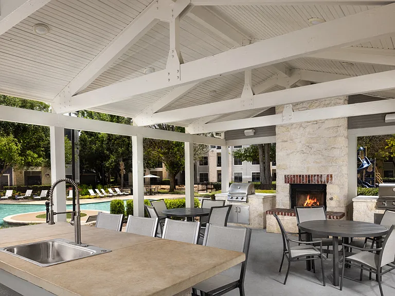 Outdoor lounge with BBQ grills, fireplace and seating