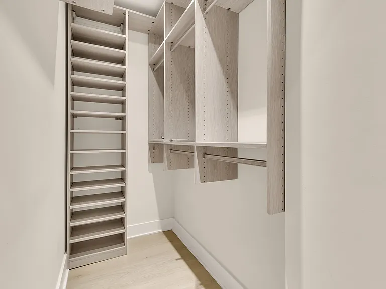 Primary closet with a custom closet system