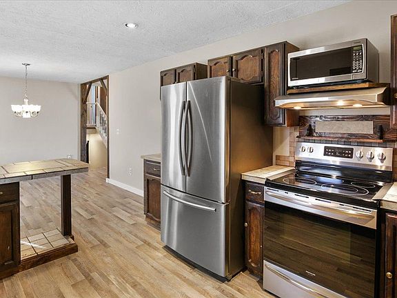 Kitchen with new flooring and newer appliances