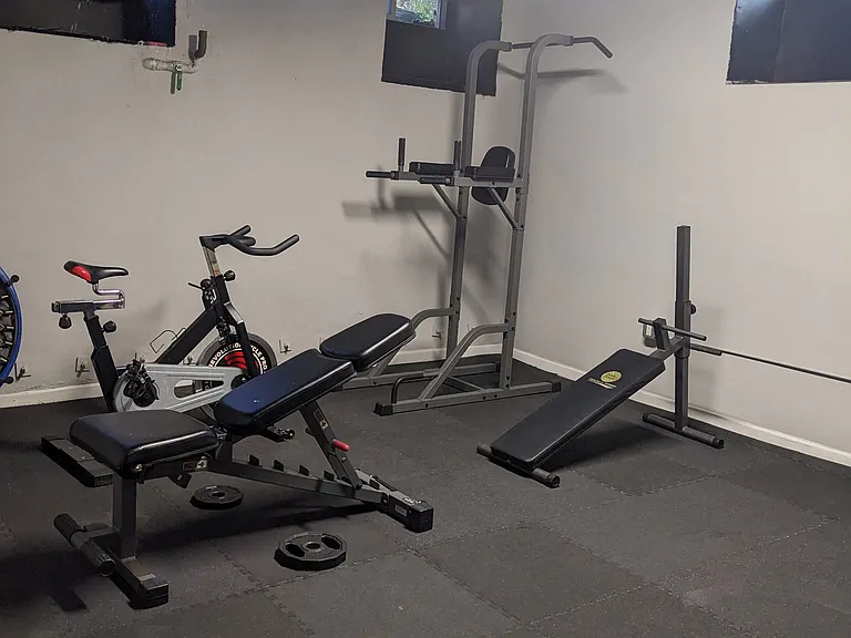 Exercise equipment in the exercise room at Molino Del Mar Apartments in Pasadena, California.