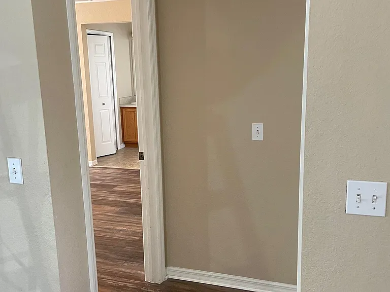 View to master bedroom from dining room, garage access on right