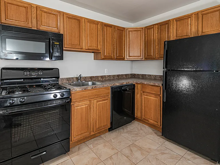 Traditional Oak cabinets with sleek black appliances
