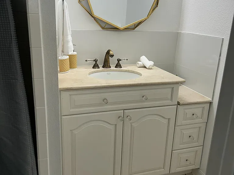 Elegant bathroom vanity with modern sink, stylish mirror, and beautiful finishes.