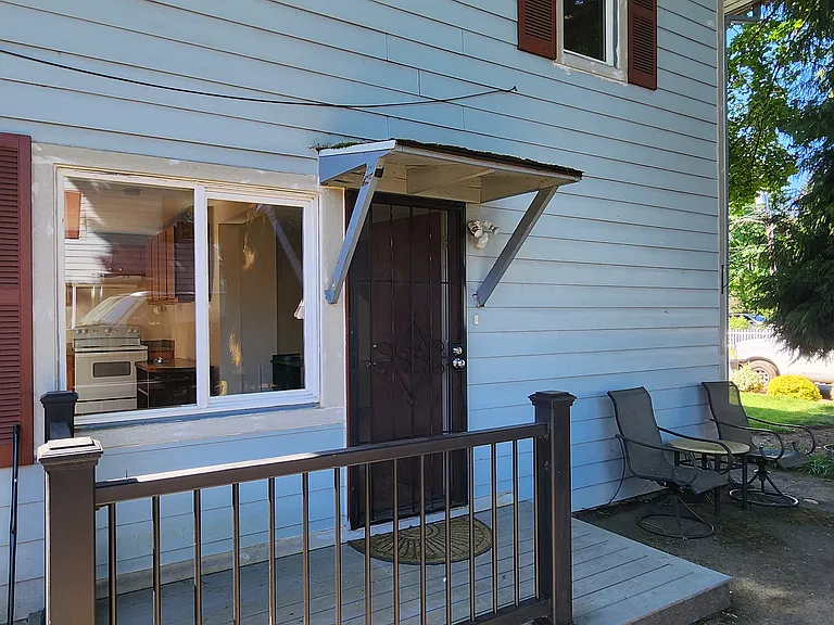 Side door with fenced deck on side of home.