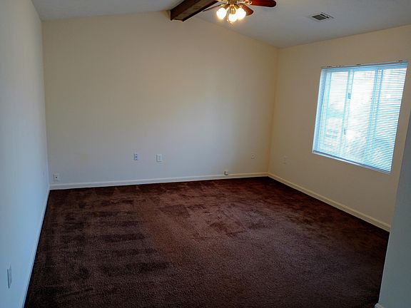 Living room is approximately 14' x 14'. Front entry is around corner in right front of photo.