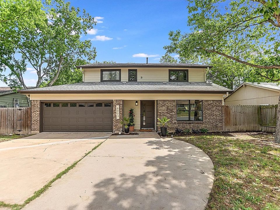 Front yard with with additional parking spaces in front of the 2 car garage