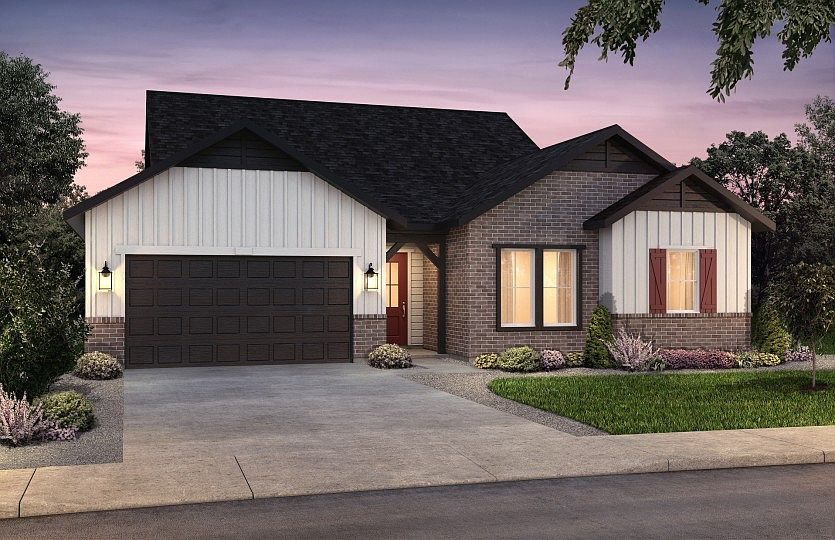 The classic farmhouse elevation boasts stylish brick accents and window shutters for added curb appe