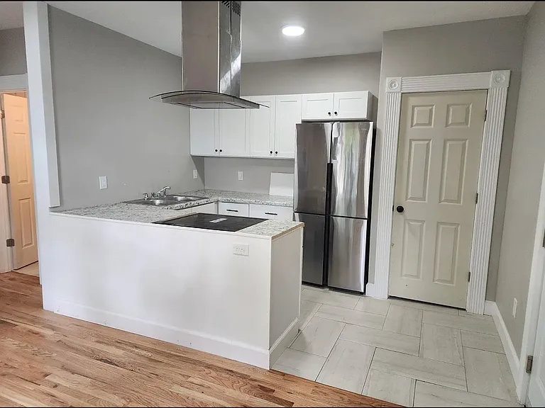 Kitchen with a closed door food pantry.