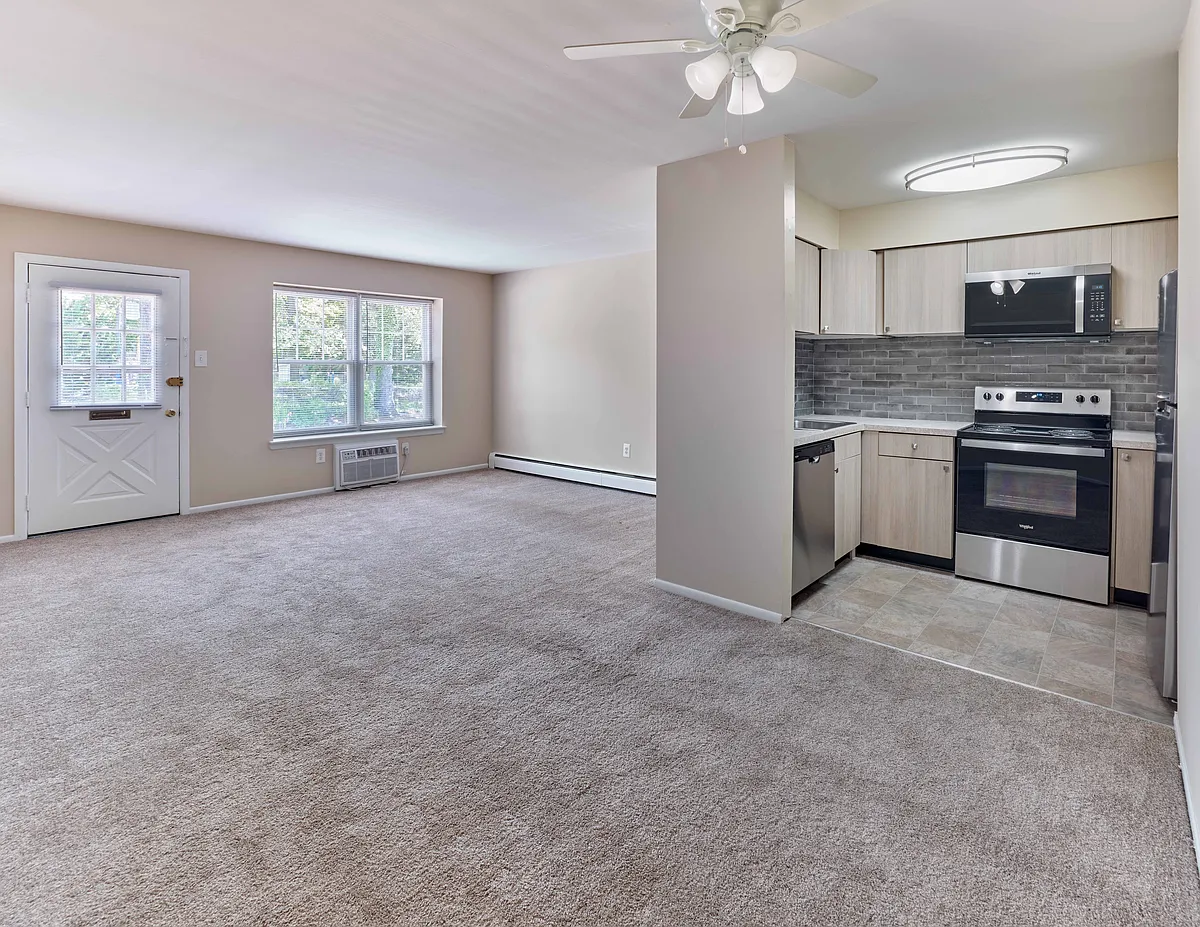Modern open-layout kitchen and living area at 42 West Apartments in Merchantville, NJ - 42 West