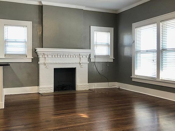 Living room with original fireplace and insert.