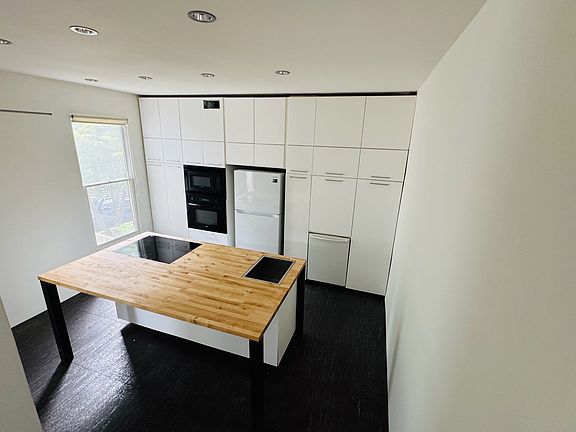 Kitchen with Bosch oven, Bosch microwave, Bosch dishwasher, Samsung induction cooktop, stainless sink, and disposal. Massive amounts of pull-out pantry and deep drawer storage.