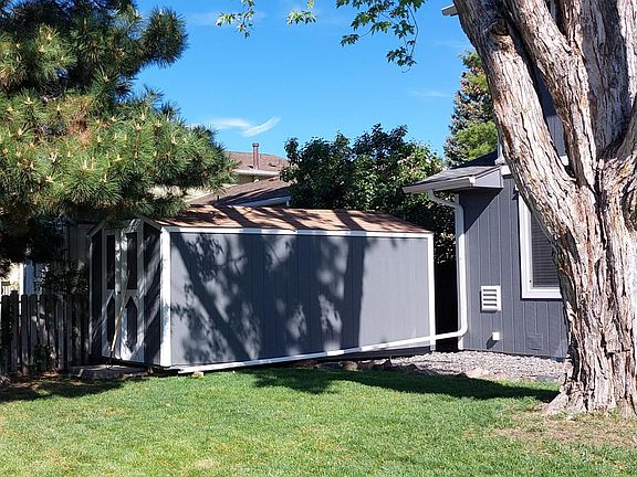 Backyard storage shed for gardening items.