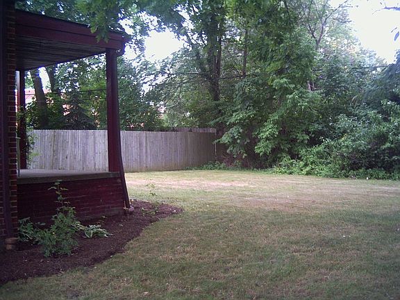 Back porch and large, private backyard abutting wooded lot