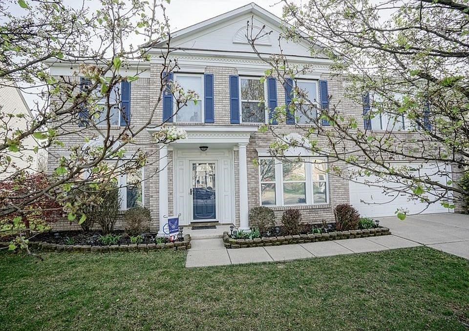 Exterior Front framed by two mature trees  enhances the curb appeal and landscaping.