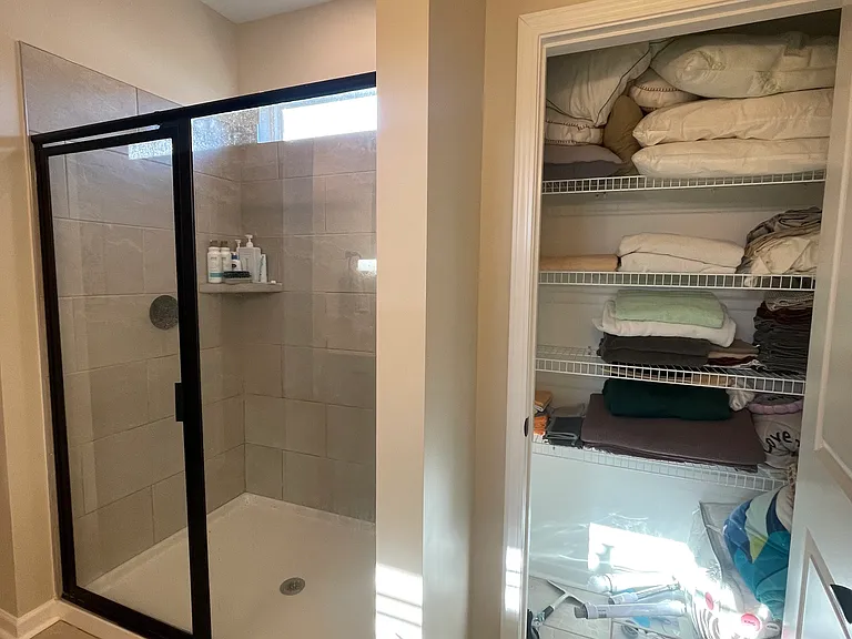 master bathroom shower and linen closet