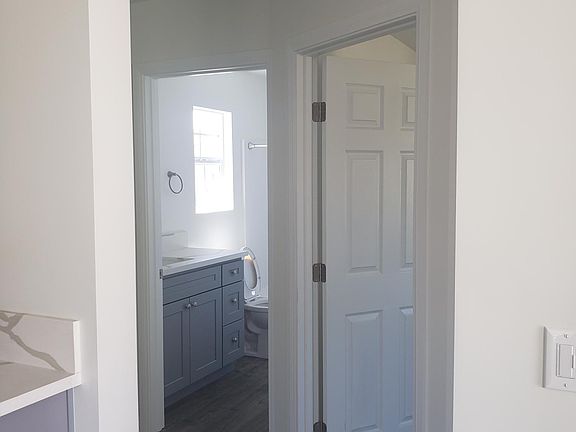 Hallway to laundry hook-up, bathroom and bedroom.