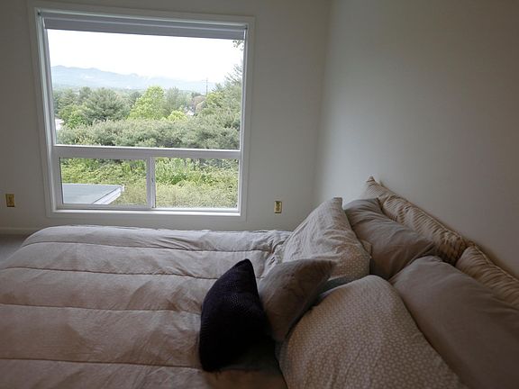 Master Bedroom with Picture window. View of Mt. range. King size bed.