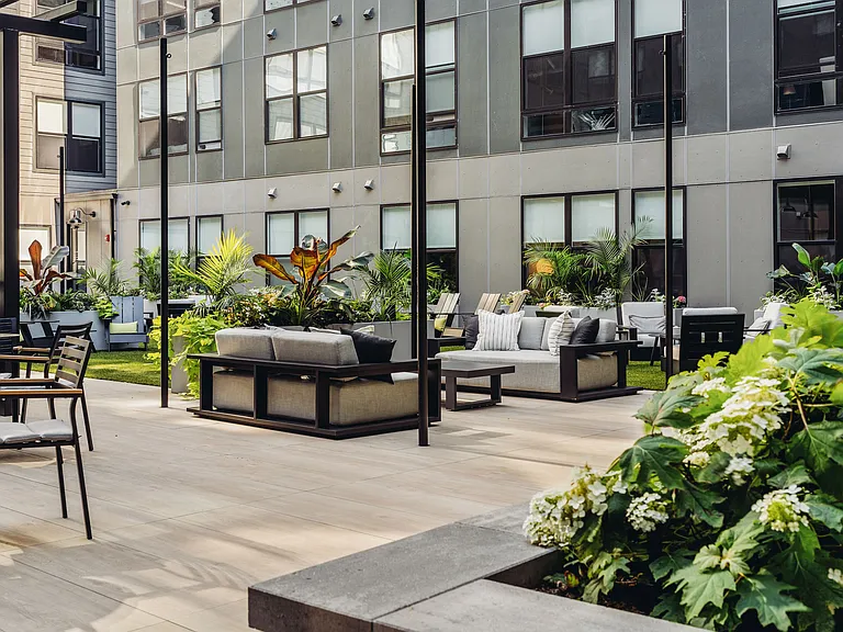 Central courtyard featuring lounge seating, bar area, outdoor tv's, and grills