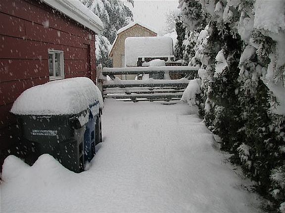 Beside garage driveway to back yard & shop