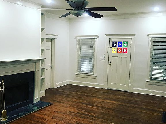 Main living room with a wood burning fireplace