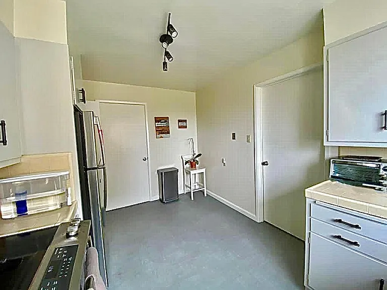 Kitchen with spacious pantry cabinet behind the door