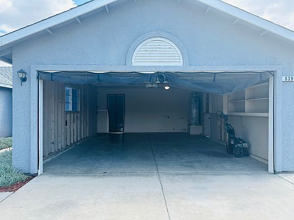Practical laundry/garage space with additional storage.