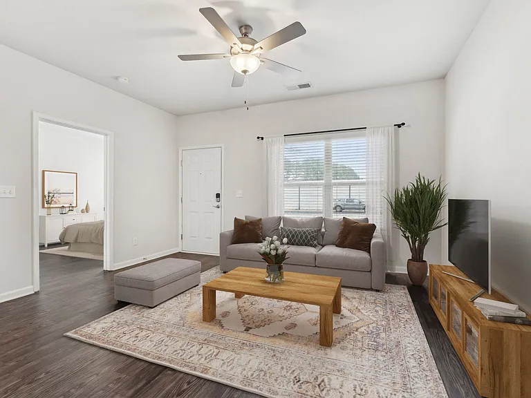 Living room with large couch and windows.