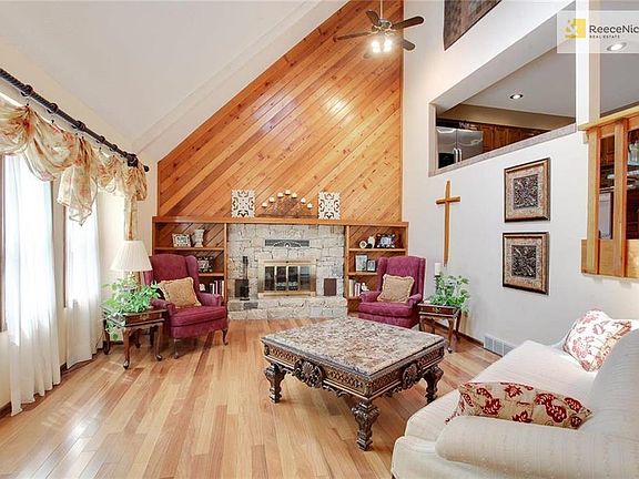 Step inside the front door into the first living space with a cozy fireplace, built-ins, and vaulted ceilings.