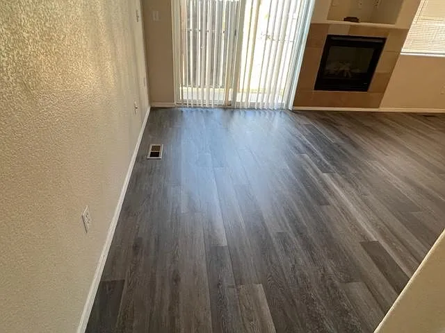 Living room area, showing the gas log fireplace and LVP flooring.