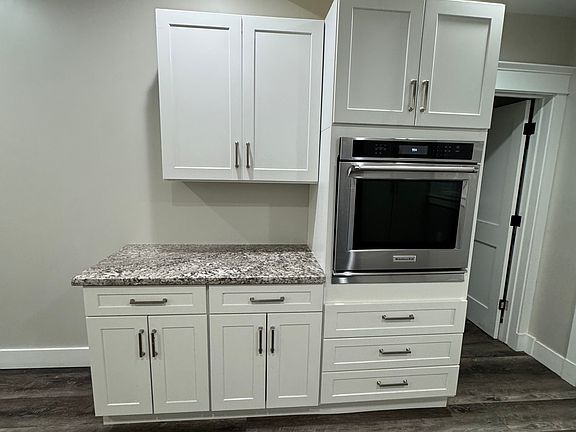 Beautiful built-in oven with ample cabinet space and granite countertops. The perfect setup for all your cooking and storage needs!