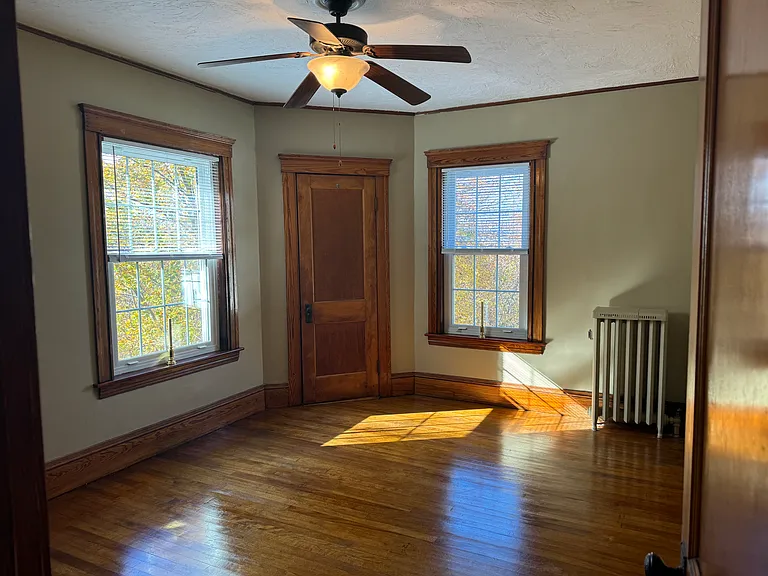 This is the back bedroom. The bathroom is located right outside of this bedroom.