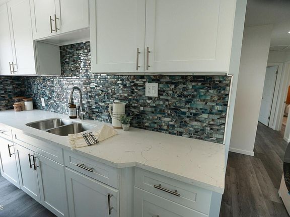 Remodeled kitchen- stylish backsplash, cultured stone counters, new cabinetry