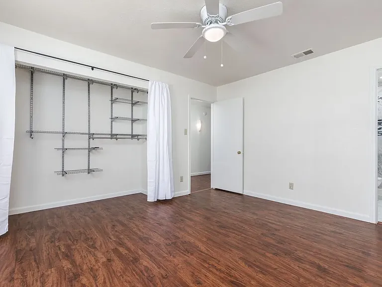 Primary bedroom showing door, closet, and primary bath