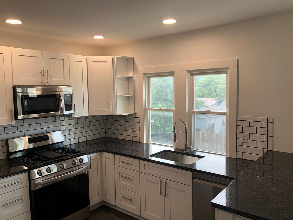 Black granite countertops, new appliances, subway tile