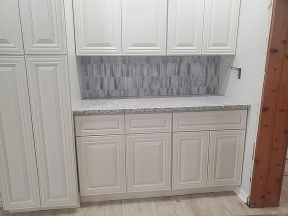 Added storage and counter space across from kitchen