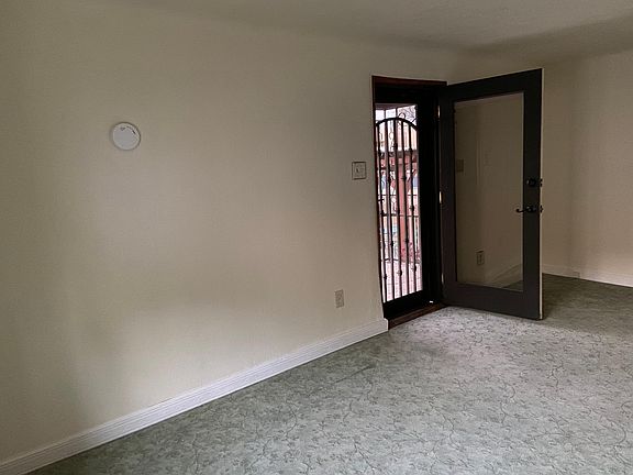Pella full glass front door, entry from elevated porch into living room with security screen door.